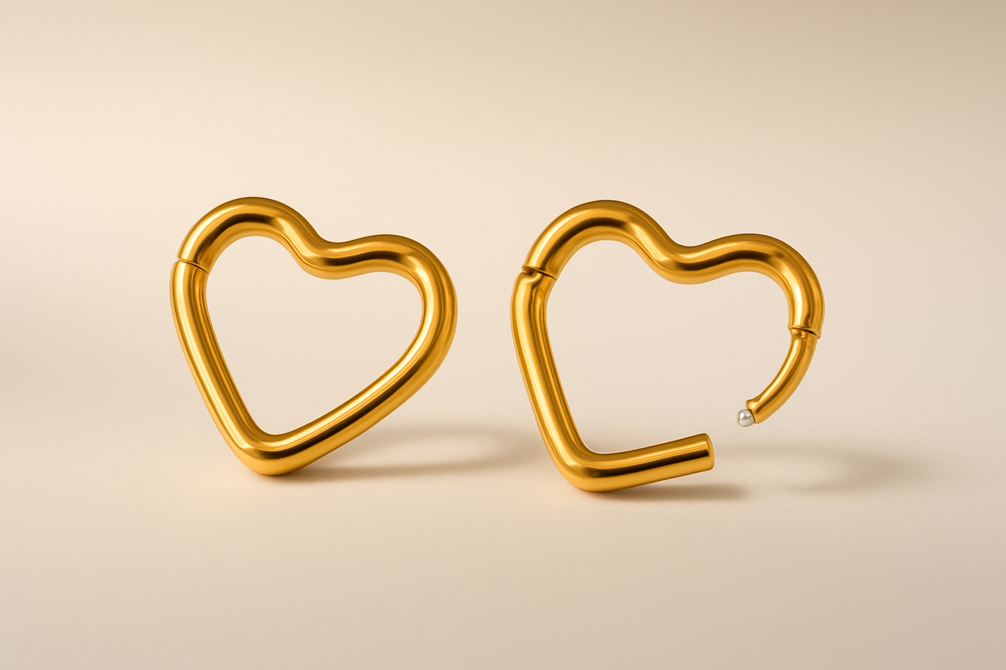 Gold heart-shaped earrings with subtle gradient background